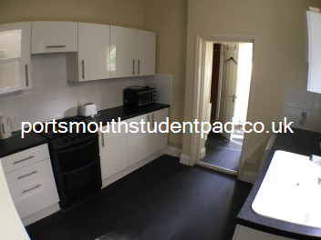 Kitchen leading to outer lobby and #2 shower and W/C